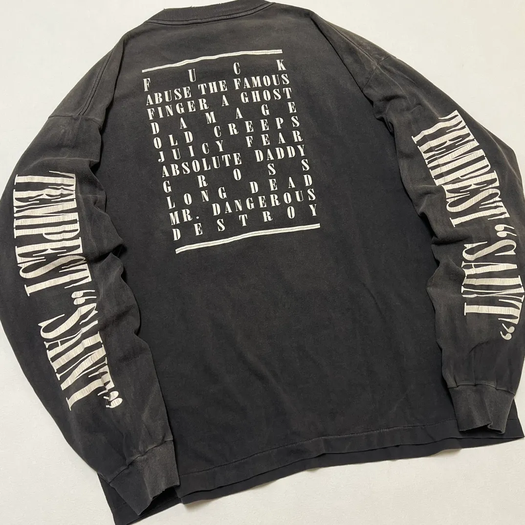 SAINT Mxxxxxx LS TEE/TEMPEST/BLK 'TEMPEST SAINT' Storm Religious Saints Cracked Retro Vulcanized Heavy Wash Long Sleeves Washed Black S-XL Assute Dyeing Multi-bit Horse Fading Craftsmanship Grinding and Hanging Holes Full of Old Feeling Top Printing Craftsmanship Purchasing Level